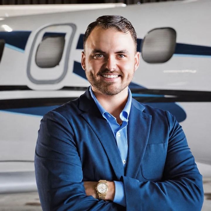 Ryan Bowne, founder of ModernWeb and former turboprop aircraft broker, standing in front of an aircraft